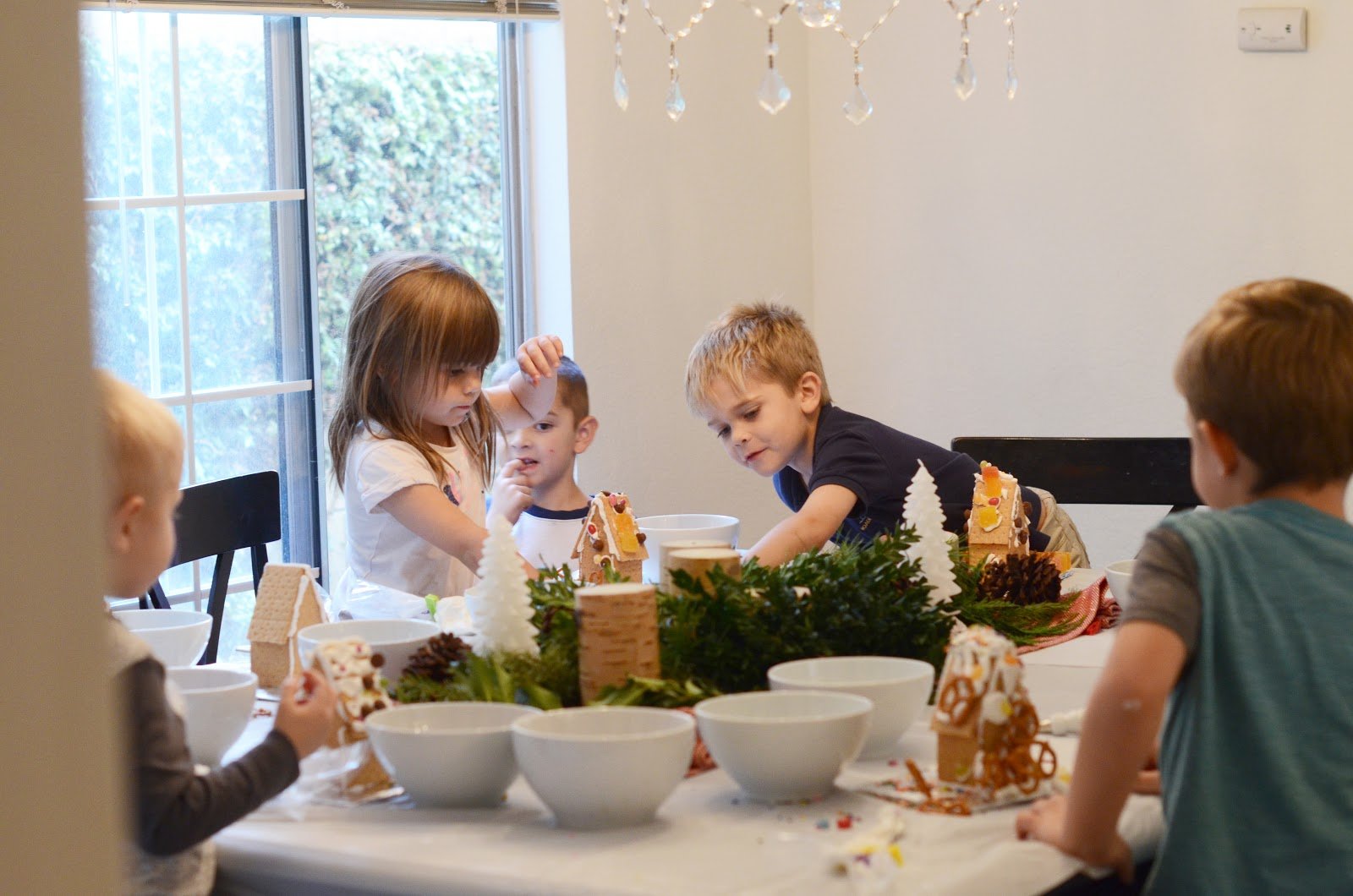 kids building gingerbread houses
