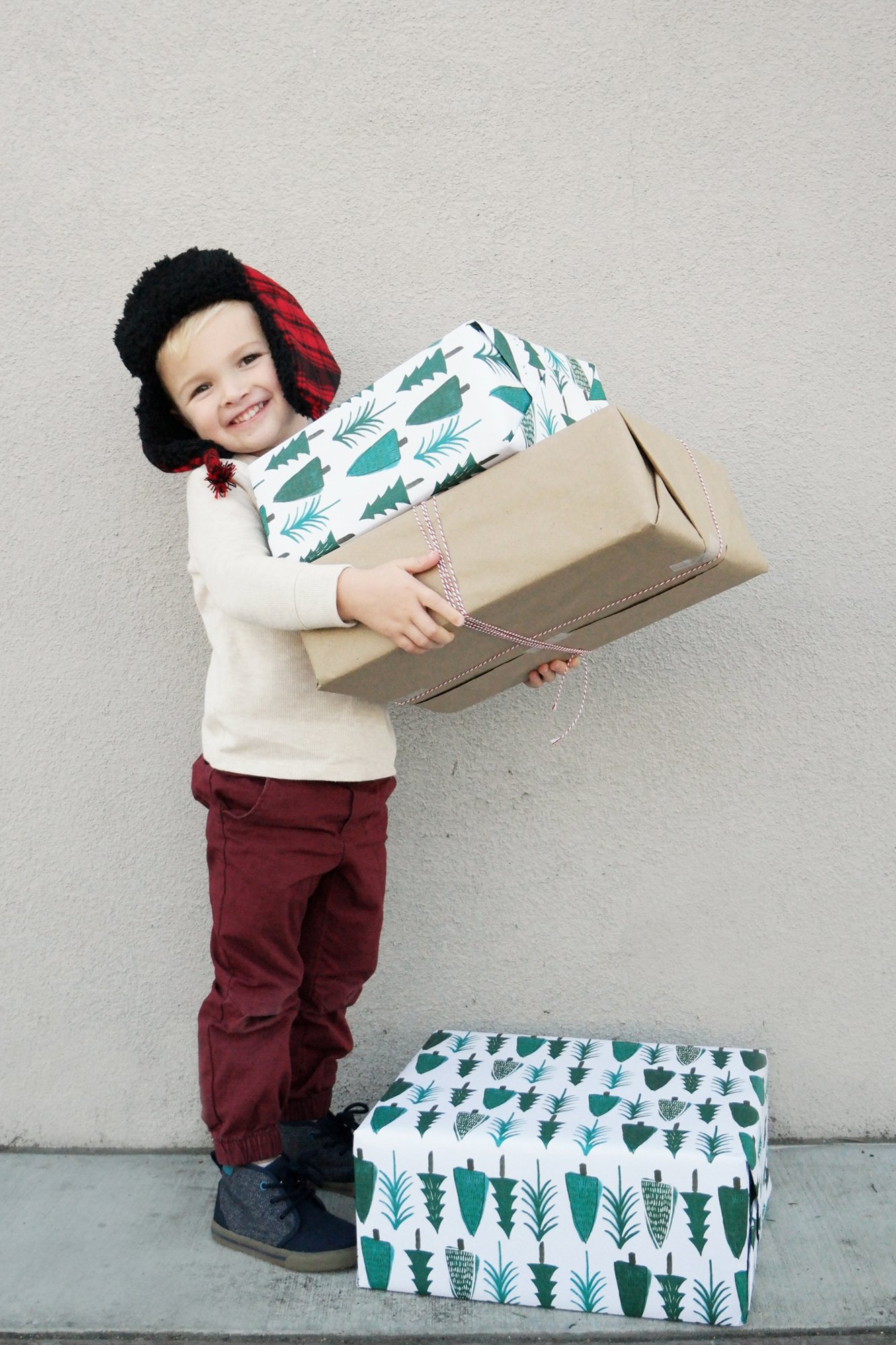 boy with wrapped christmas presents