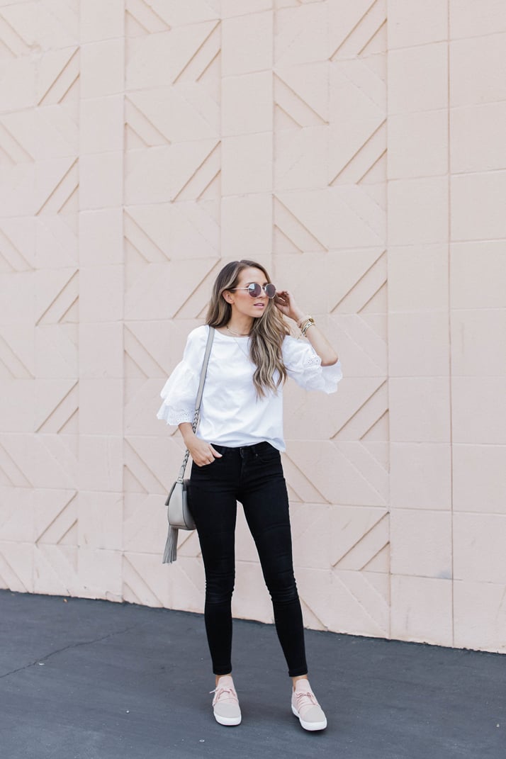 dress down a bold black and white outfit with some blush sneakers