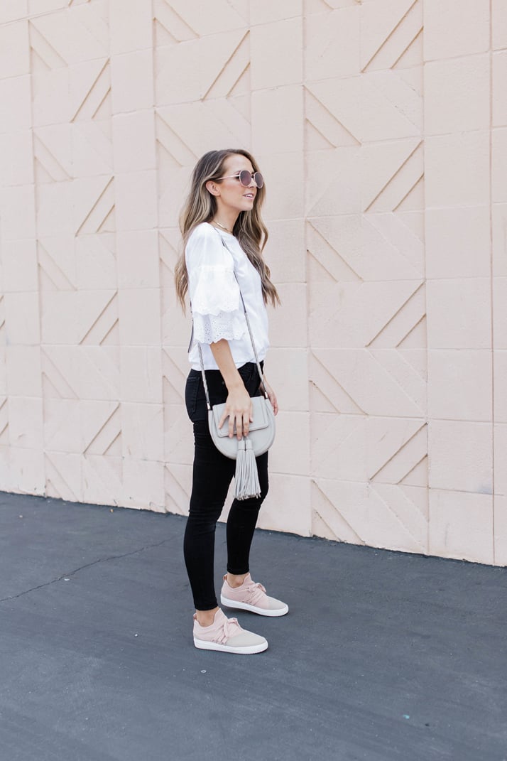 a bold black and white outfit with blush pink slip on shoes
