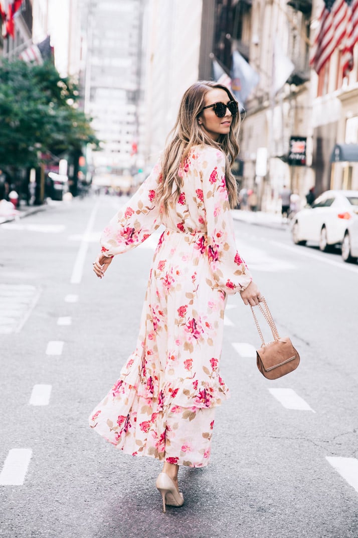 running down the streets of new york city in a floral maxi dress