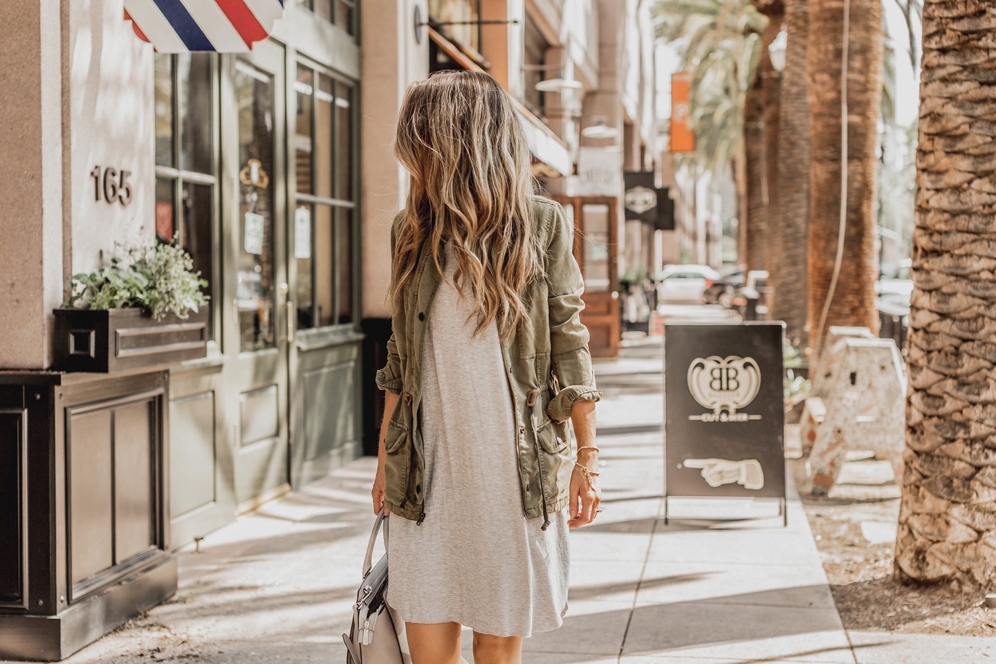 an easy gray t-shirt dress with an olive jacket