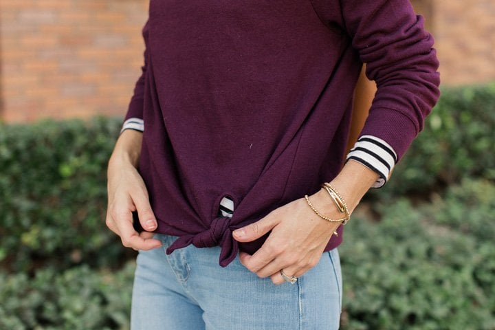knotted sweatshirt and stripes peeking out
