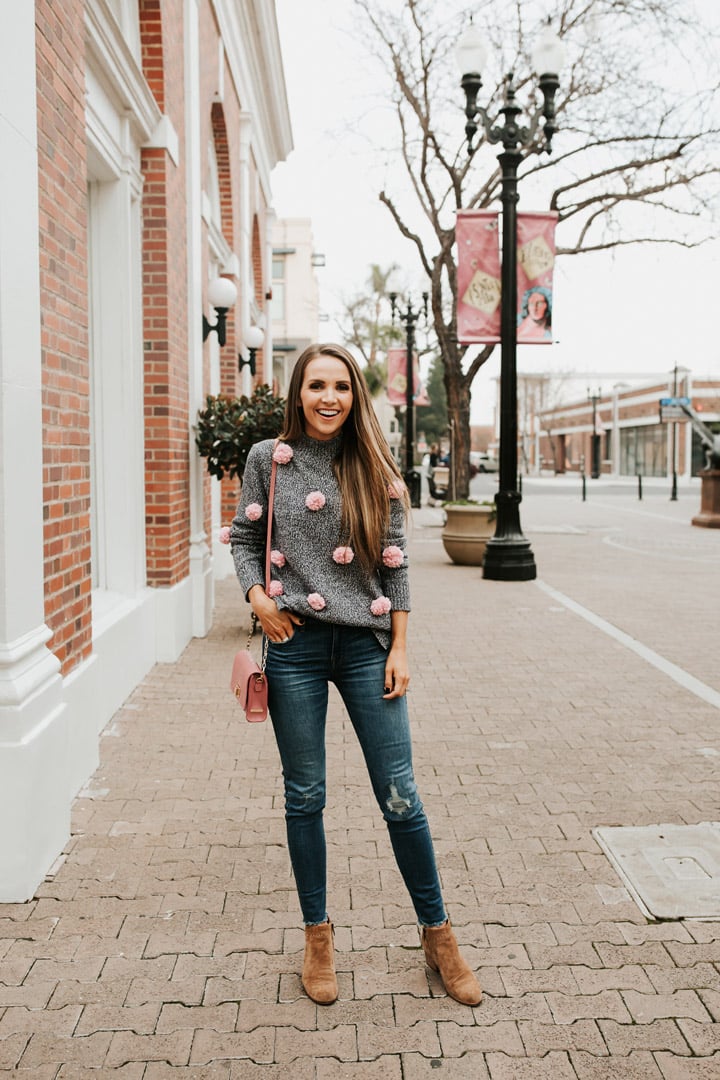 a cozy winter outfit with this cute pom pom sweater