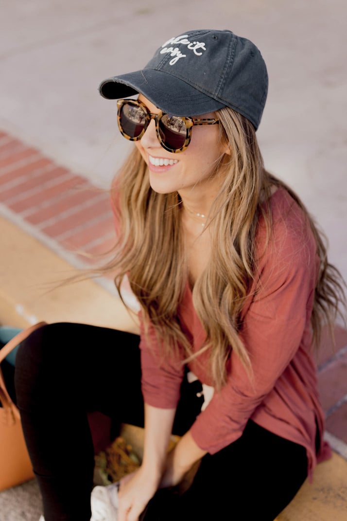 black joggers and a baseball cap