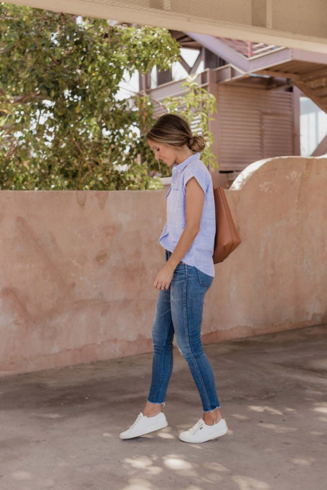 White sneakers with jeans and blue pinstripe top