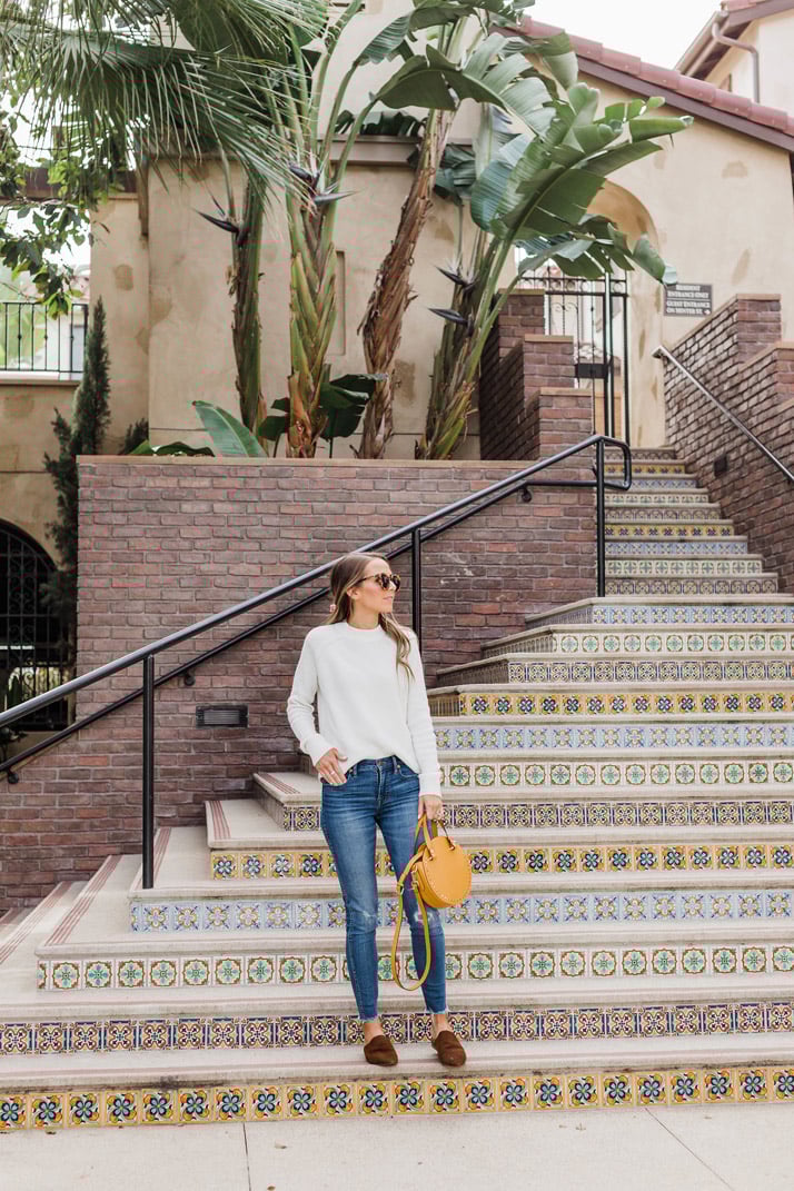 beautiful tiled staircase and a simple white sweater and jeans outfit