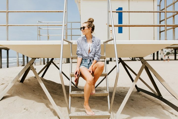 toss a button down shirt over your swimsuit for an effortless beach look