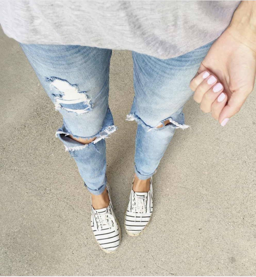 distressed jeans and sneakers