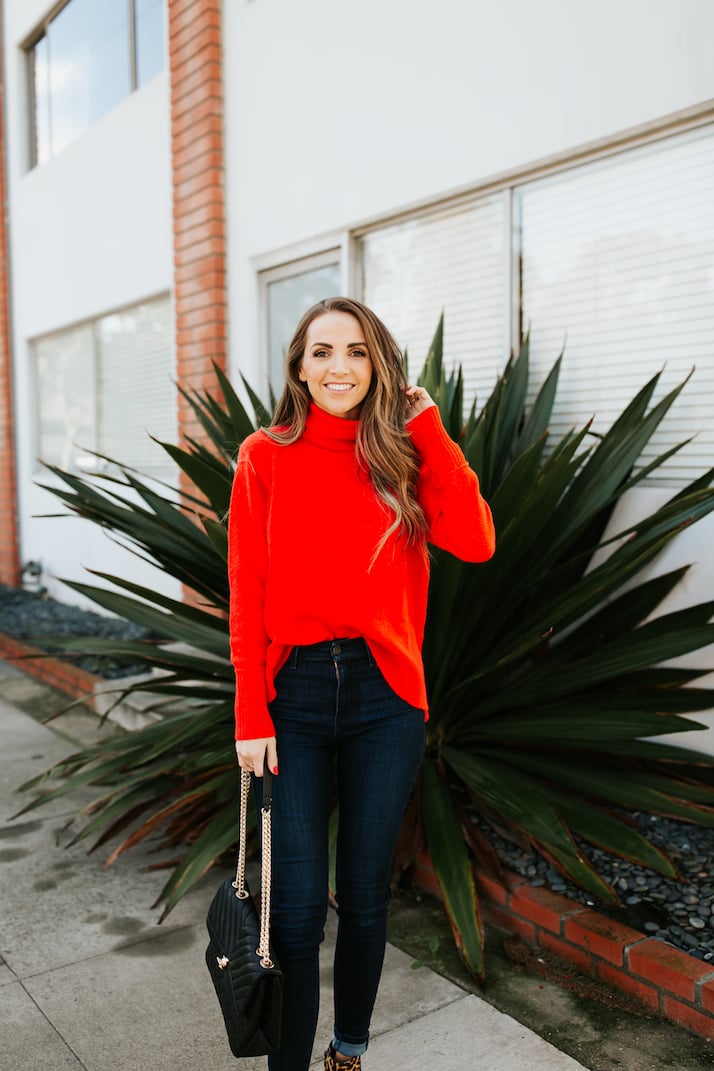 red j.crew turtleneck sweater and dark wash jeans