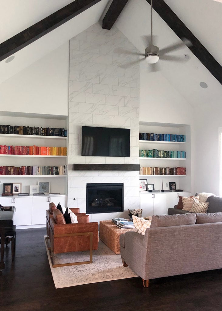 living room with fireplace and rainbow bookshelf