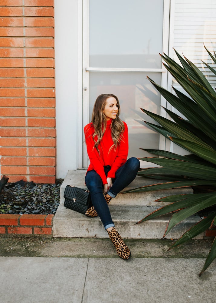 red turtleneck sweater with dark jeans and leopard booties