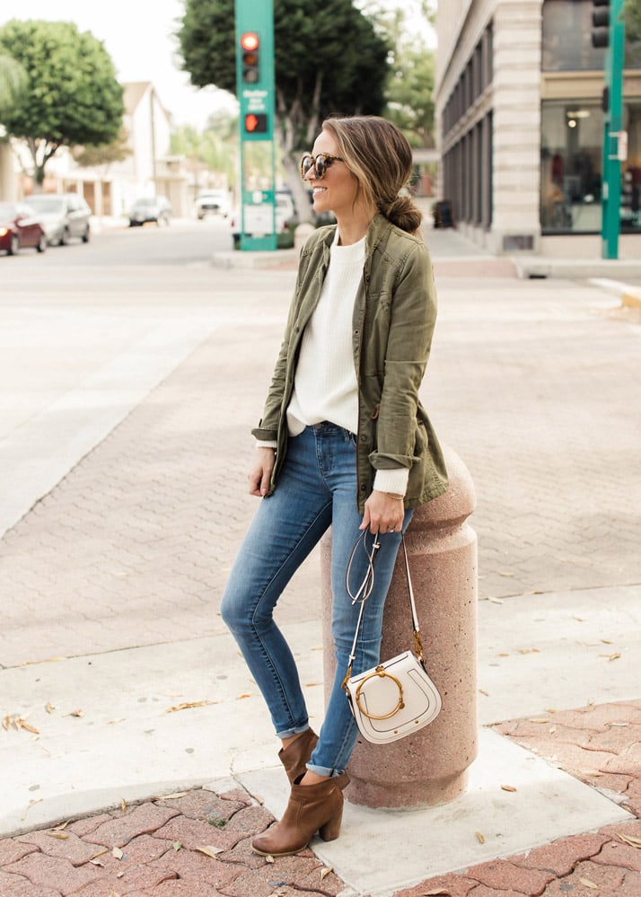 olive jacket with cream sweater and jeans - how to wear jackets in the fall