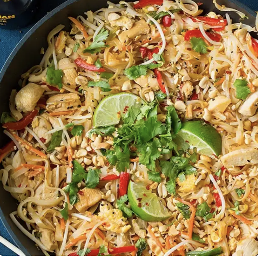 chicken pad thai in a wok