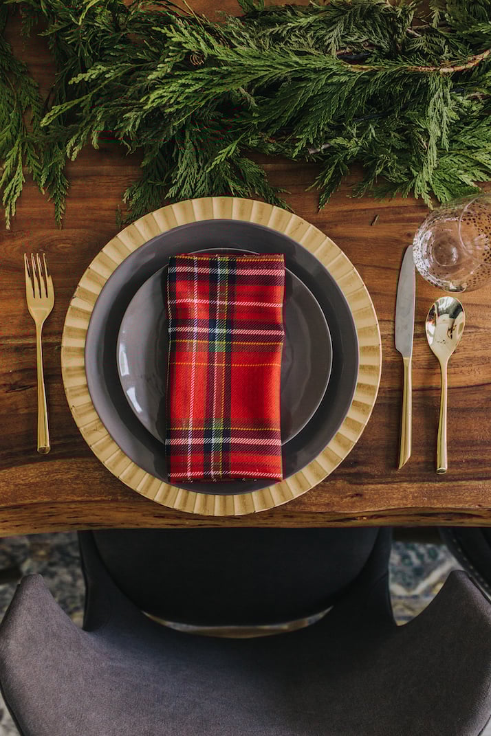 red plaid napkins, gold charger, gray table setting