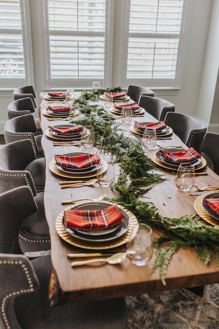 live edge table with gray and gold table setting with red plaid napkins