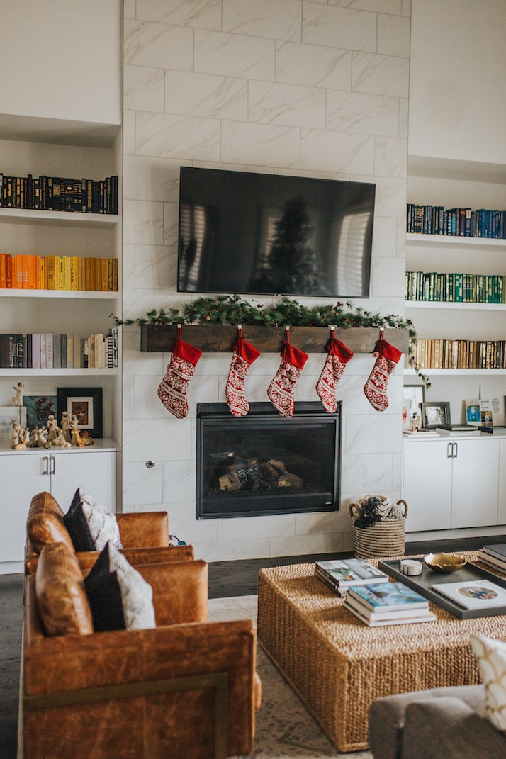 tile fireplace with wood block mantle and leather chairs