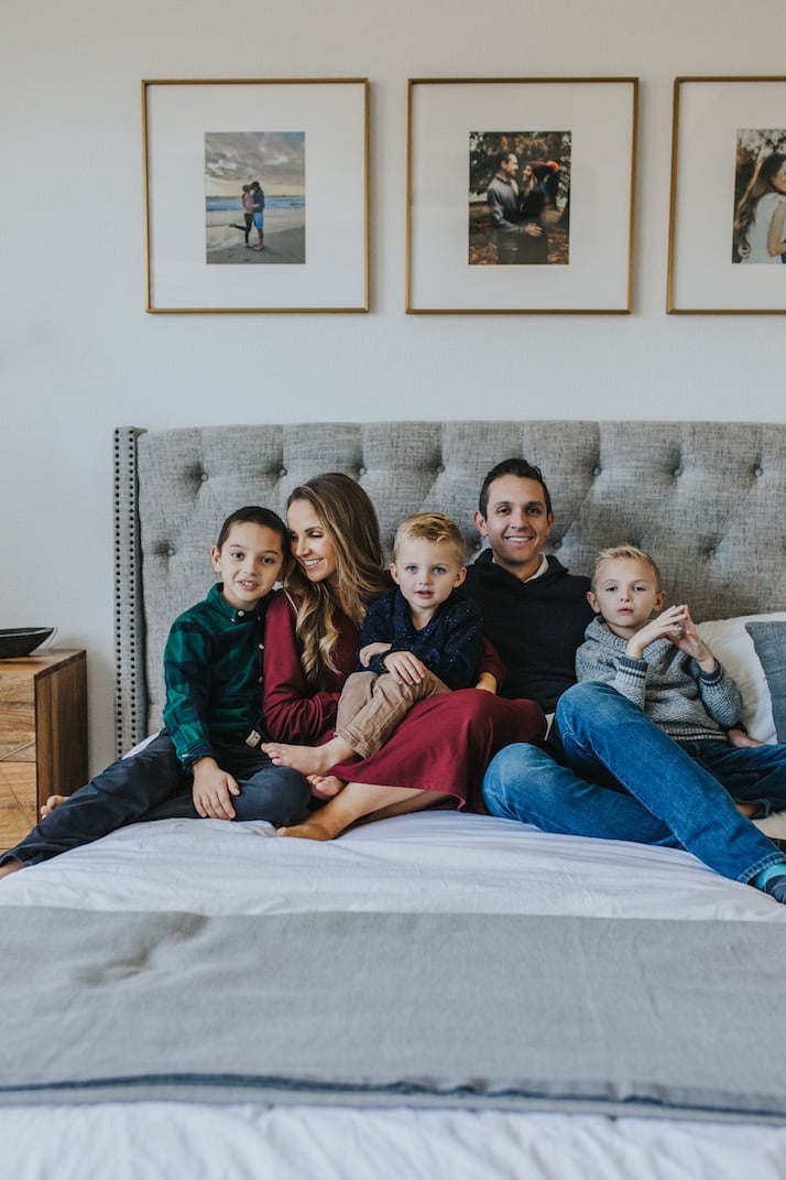 family snuggled on the bed