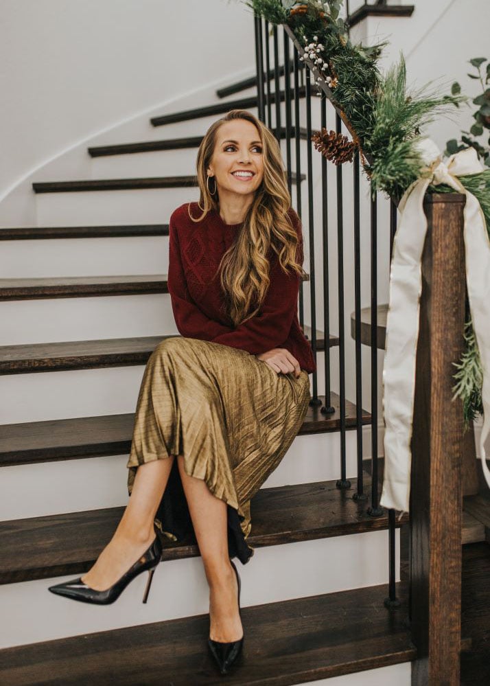 Burgundy sweater and gold pleated skirt