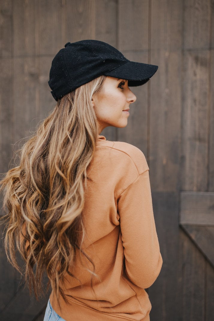 black baseball cap with sweater