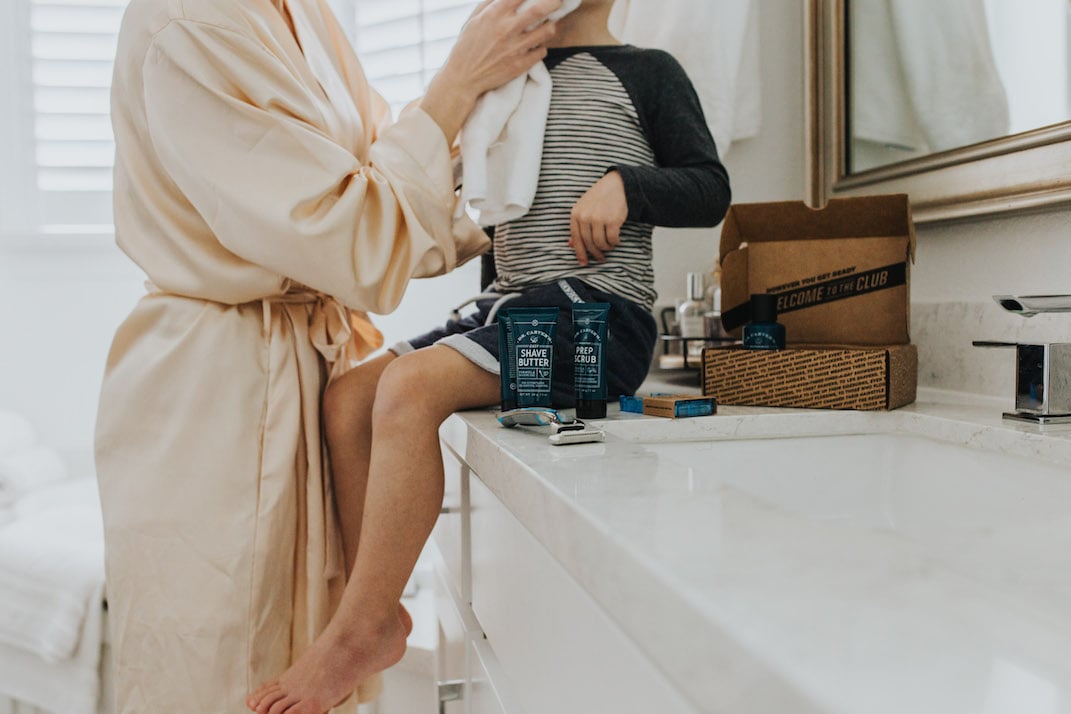 bathroom with boy on the counter