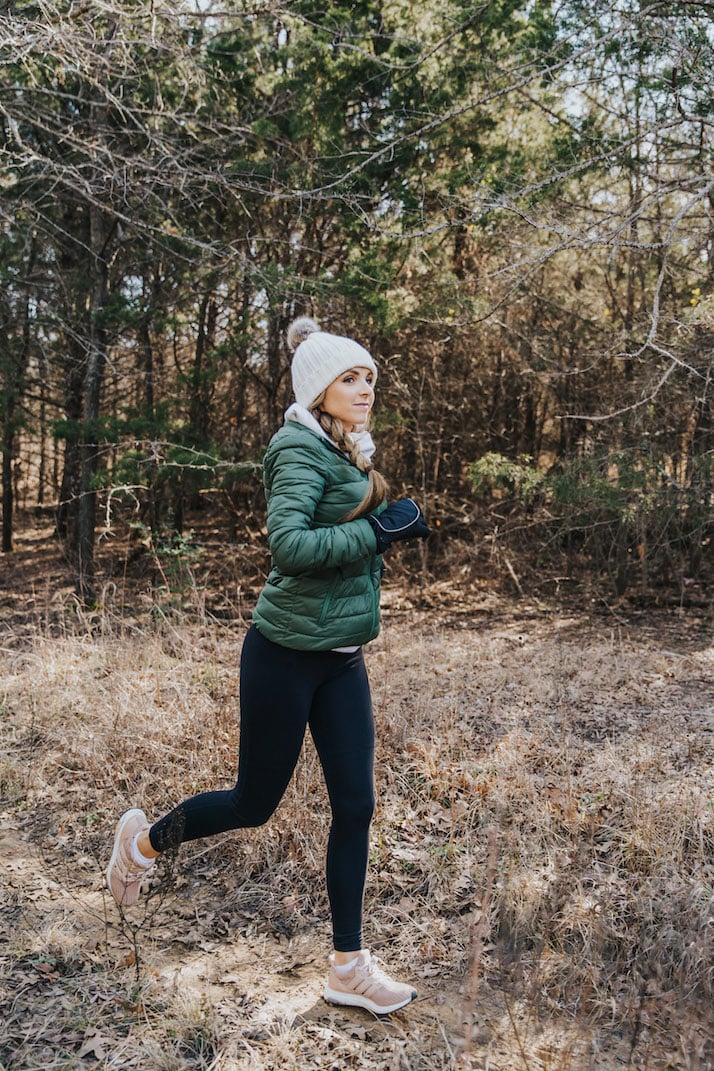 running in green puffer jacket