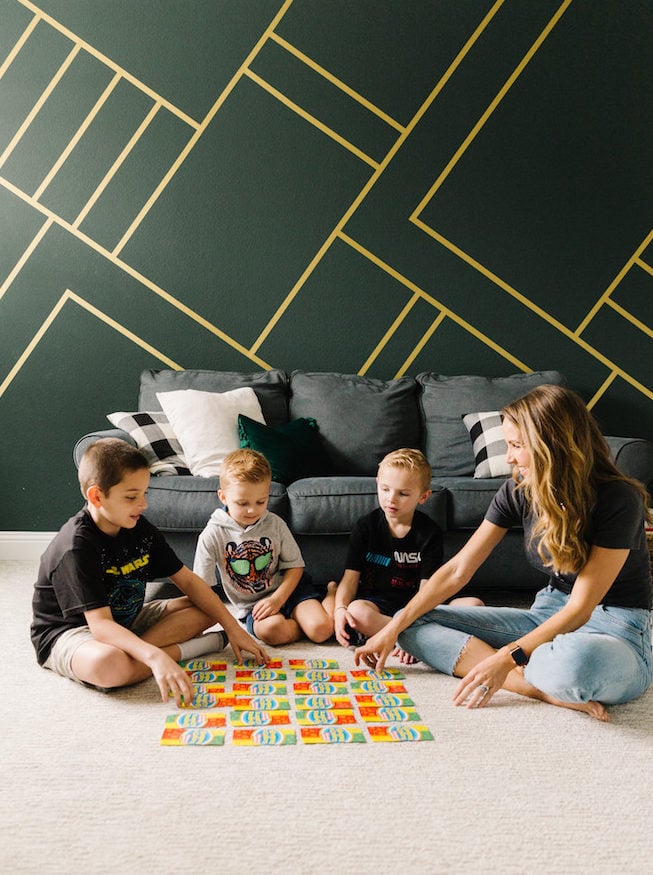 green wall with gold wallpaper stripes