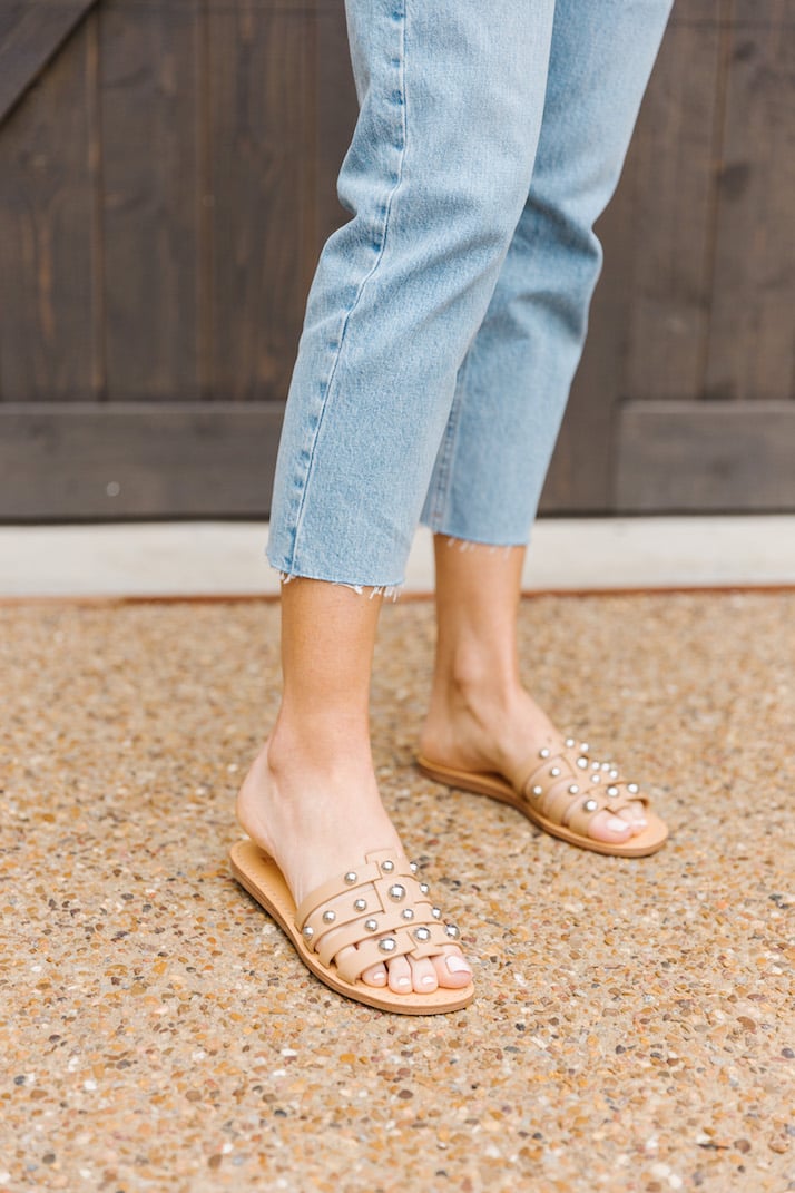 studded sandals and light wash jeans