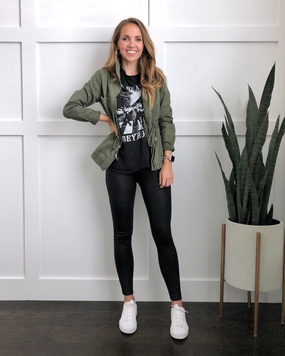 olive jacket with leather leggings and graphic tee