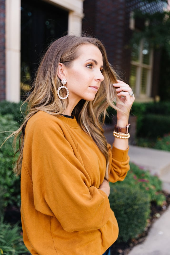 sweatshirt with pearl hoop earrings