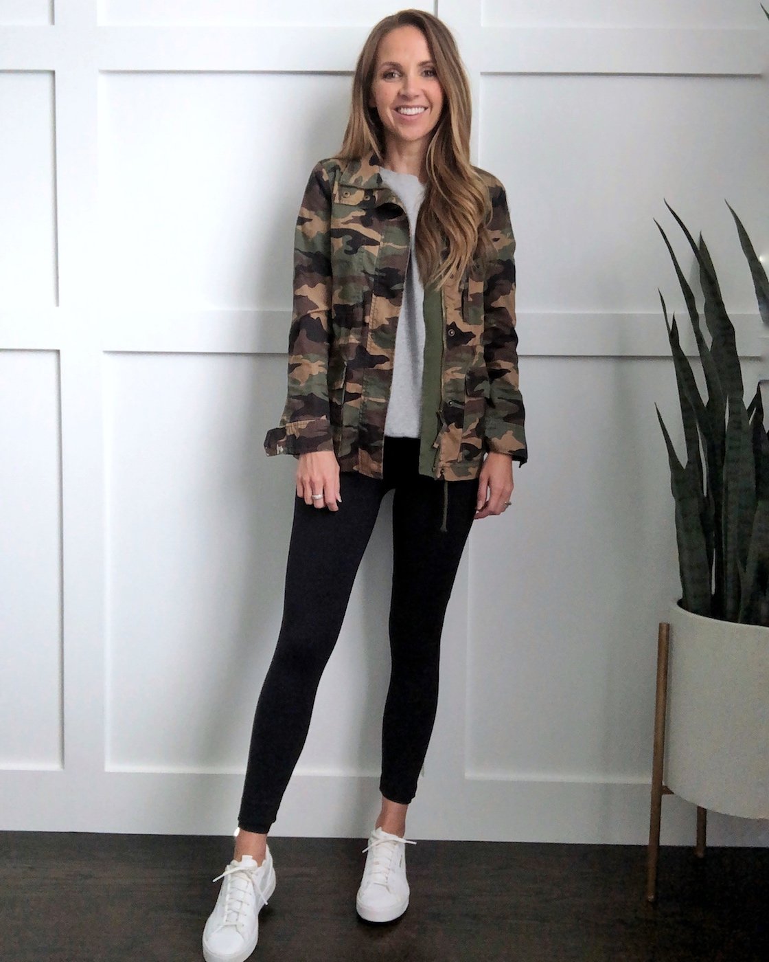 white sneakers in the fall: black leggings and camo jacket