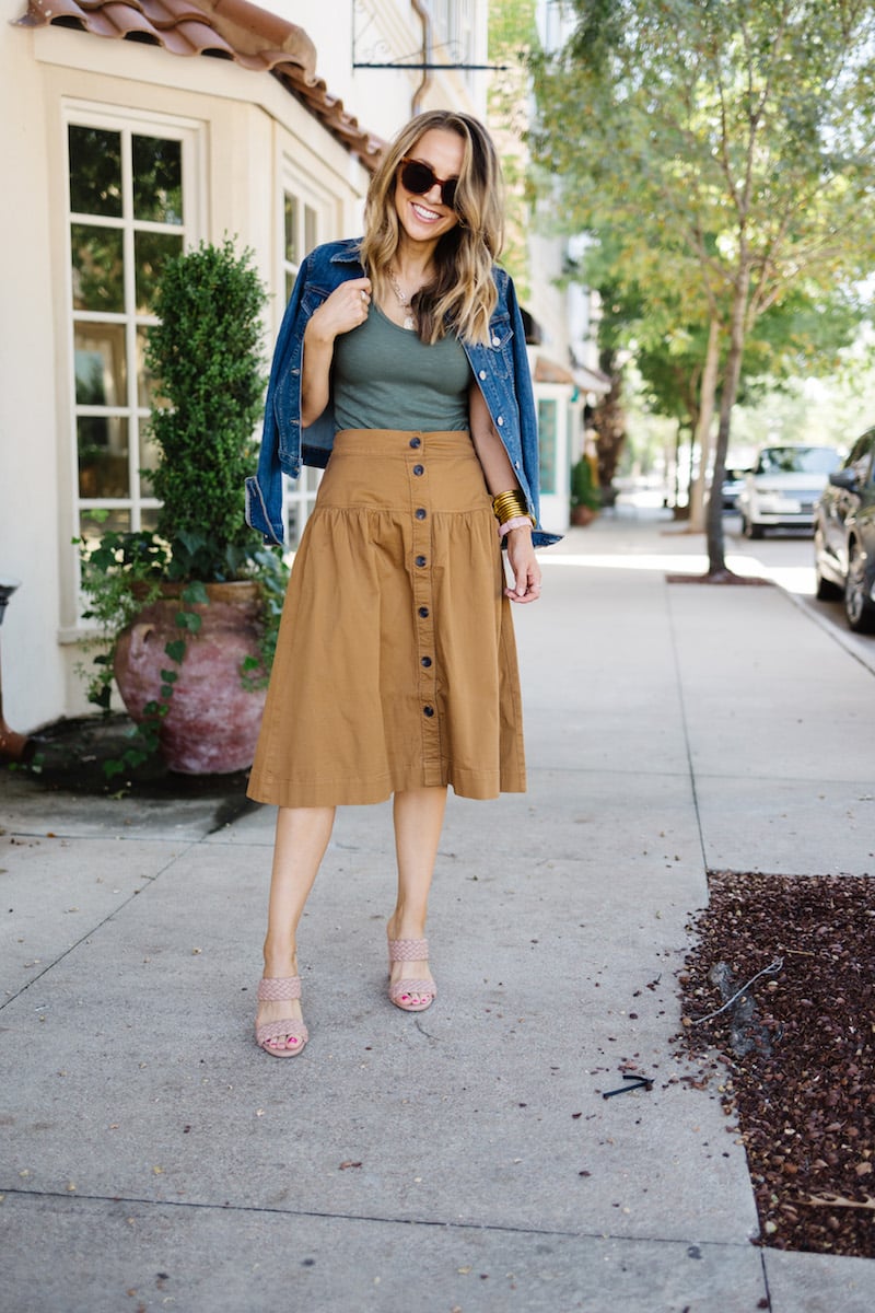 green bodysuit with denim jacket and brown skirt