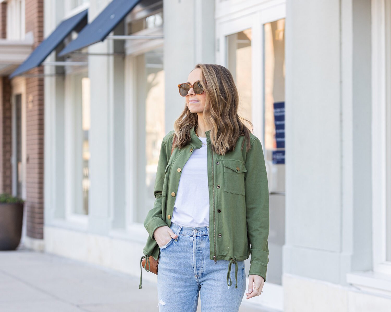 green jacket with light wash jeans