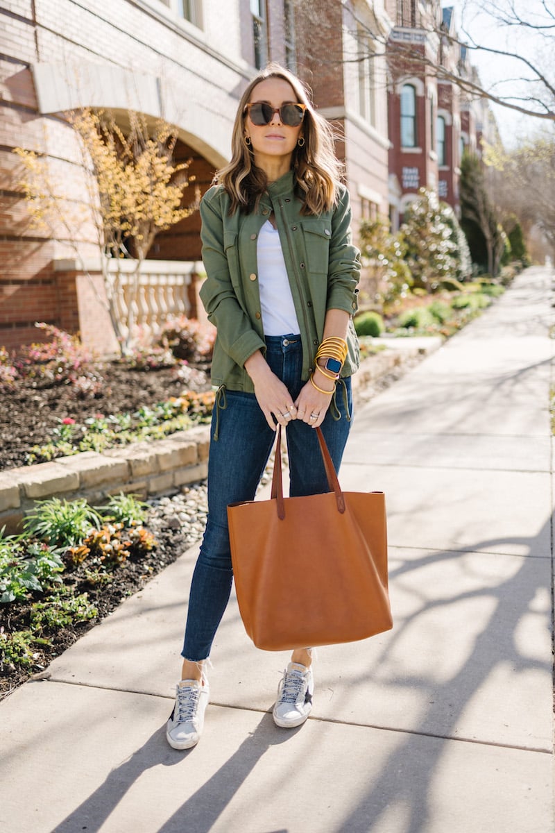 golden goose sneakers with olive jacket and good american jeans