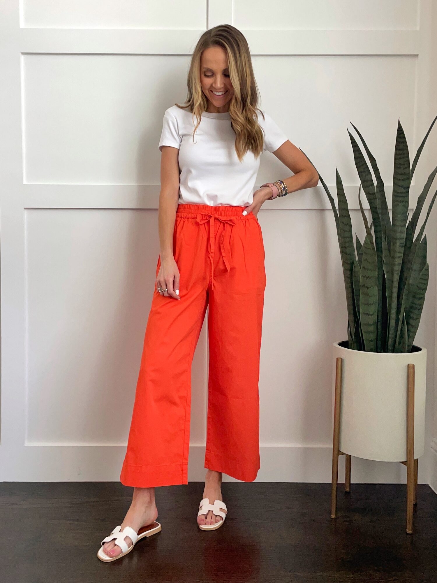 orange cropped pants with white tee