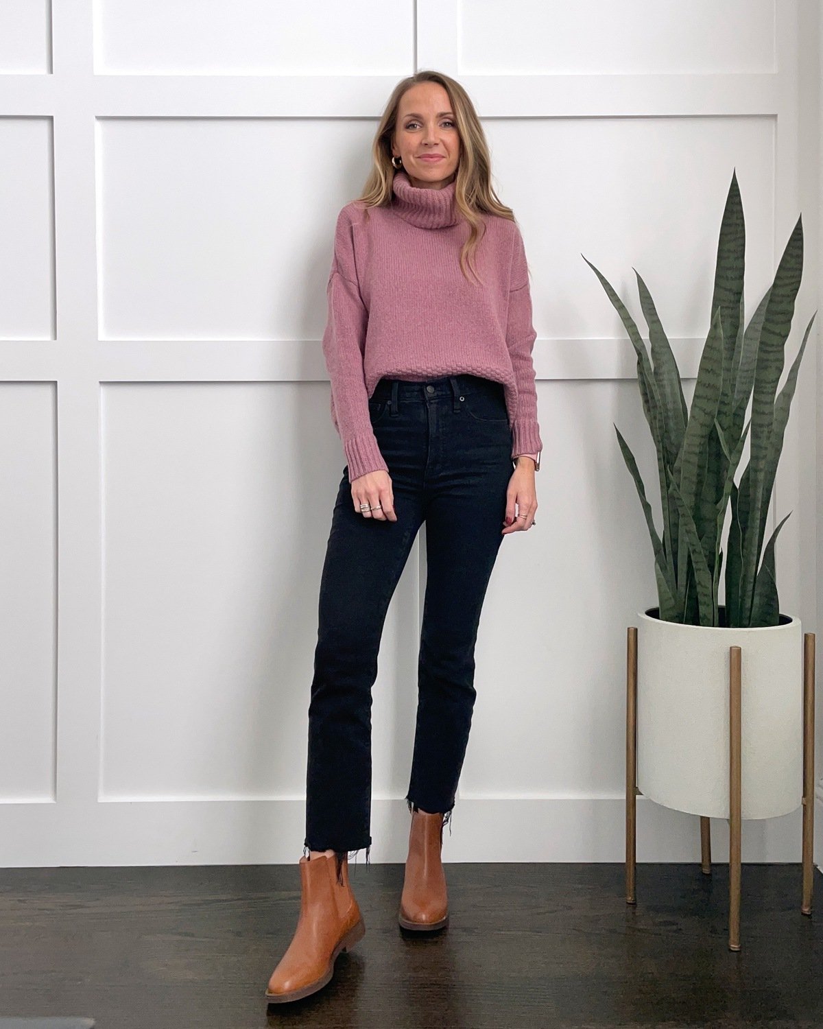 black jeans pink sweater Chelsea boots